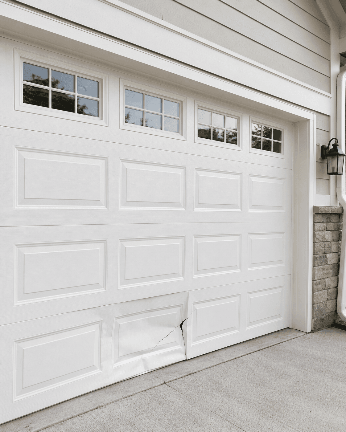 Damaged lower panels on a residential garage door