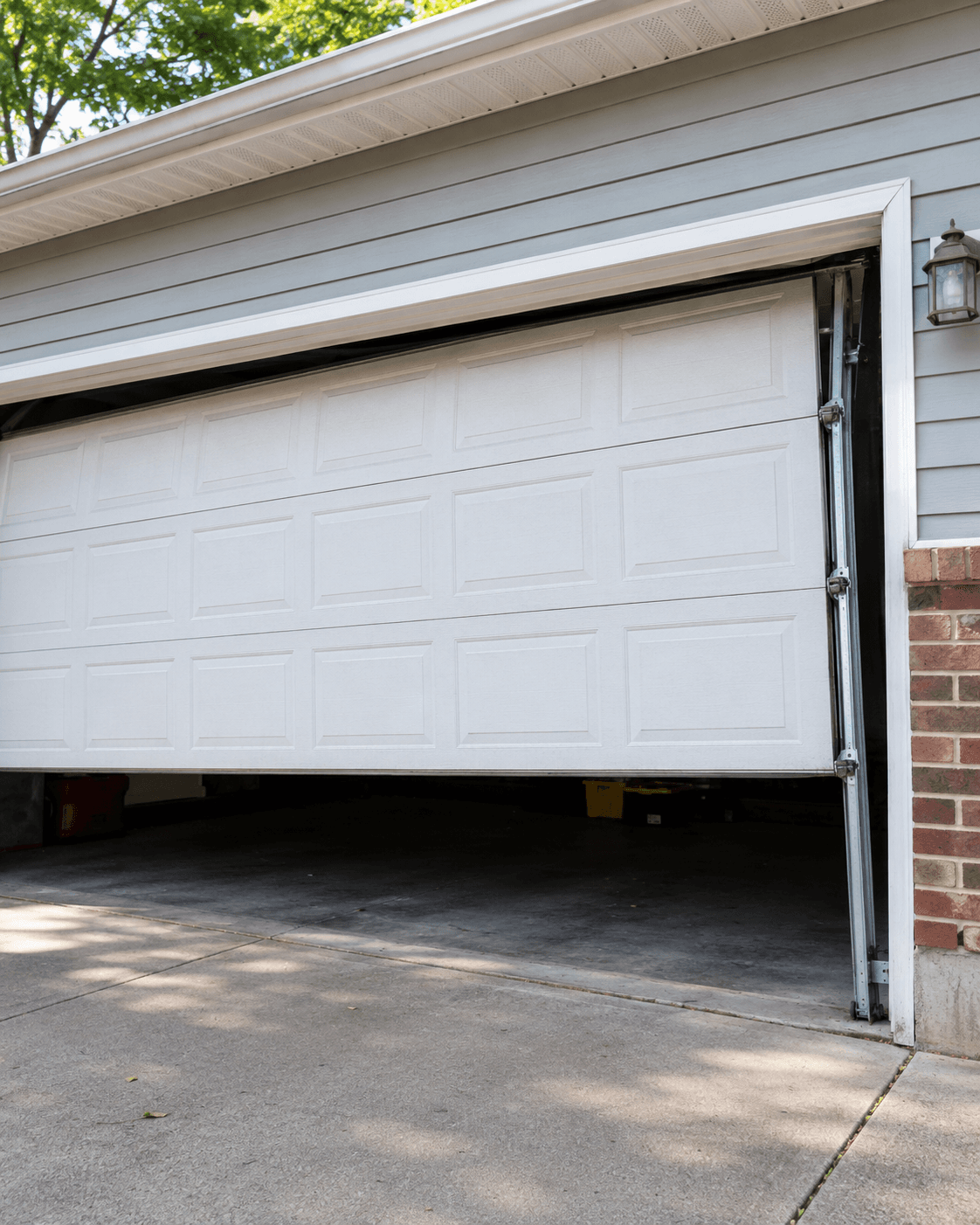 Residential garage door partially outside its side track