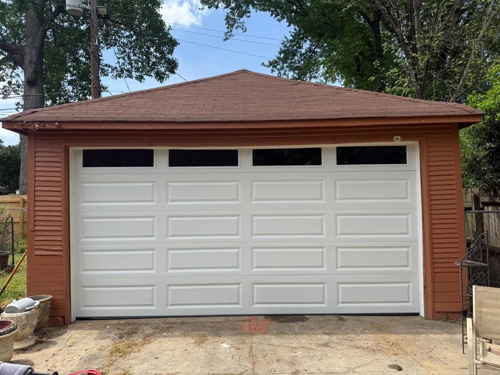 White raised-panel garage door with a row of dark top windows