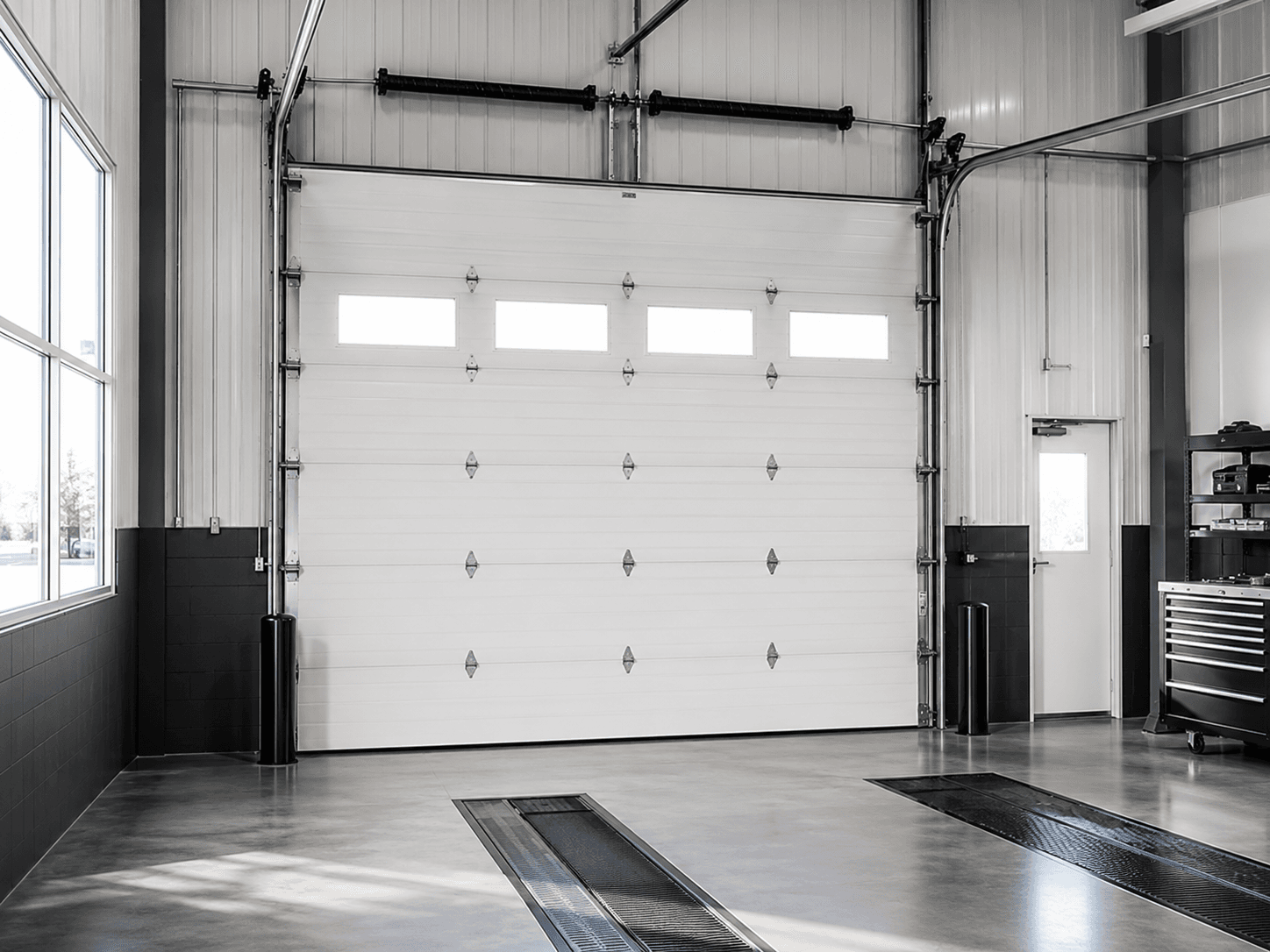 Commercial sectional overhead door inside a service facility